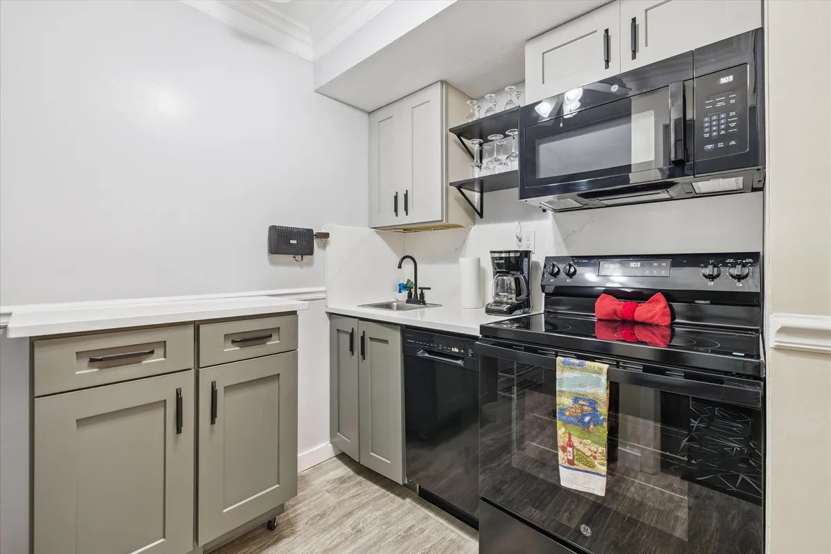 A sleek, modern kitchen boasting stainless steel appliances, clean countertops, and stylish cabinetry. The kitchen is designed for both functionality and gatherings, with plenty of space for meal prepping or socializing around the island.